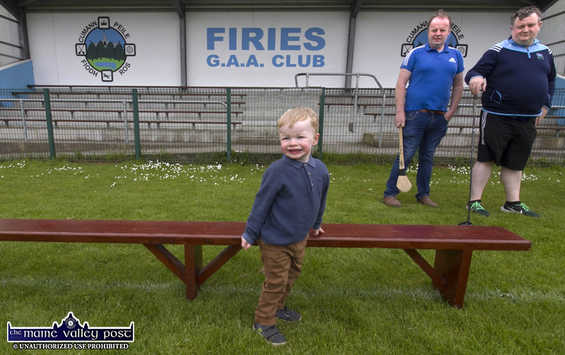 Two-year-old Tadhg Dónal McCarthy-Cronin from Barradubh is waiting impatiently for family members to join him on the bench for the group photograph with club members Brendan Spring and Dermot O'Connor also in the queue at the Firies GAA Club / Donie McCarthy Memorial Golf Classic Launch at club headquarters in Farranfore on bank holiday Monday. ©Photograph John Reidy